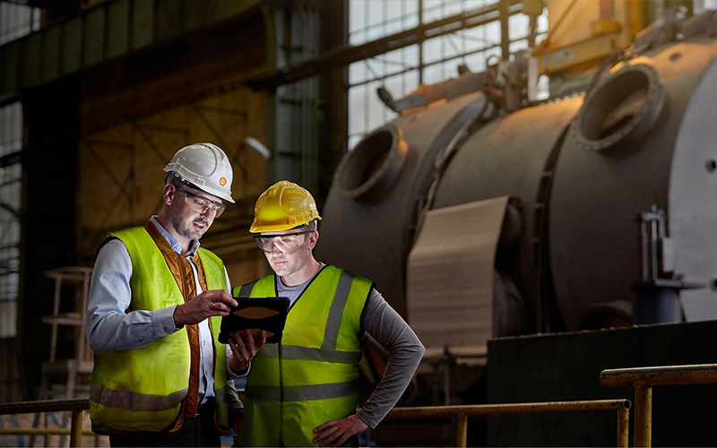workers in safety gear inspecting data