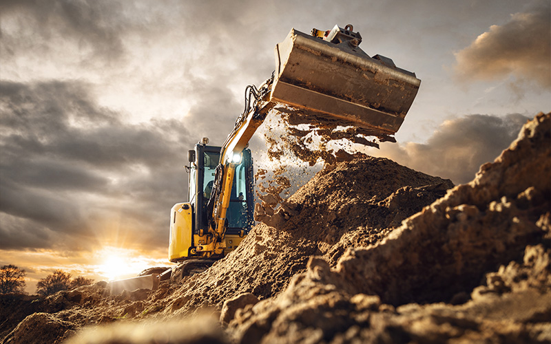 excavator moving soil at a construction site